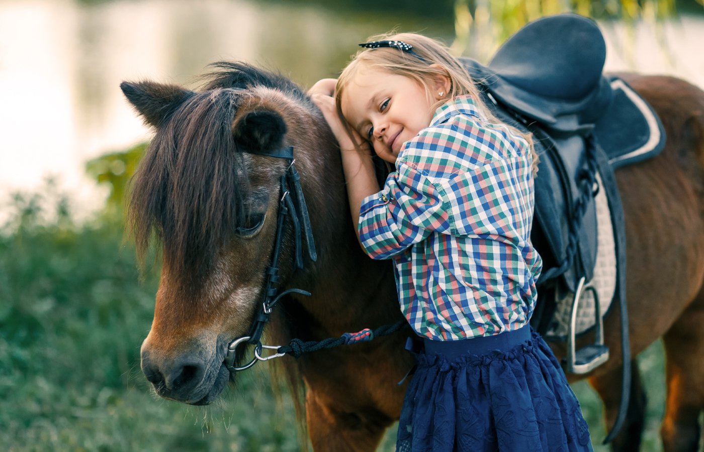 A girl hugging a pony